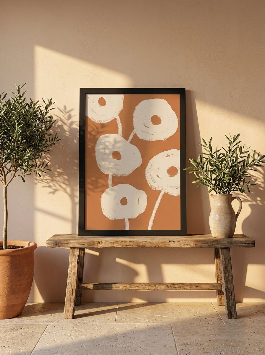 Modern wall art print standing on a bench in a Mediterranean bedroom