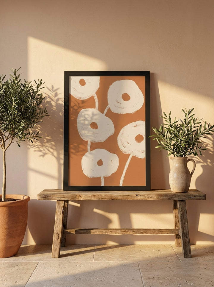 Modern wall art print standing on a bench in a Mediterranean bedroom