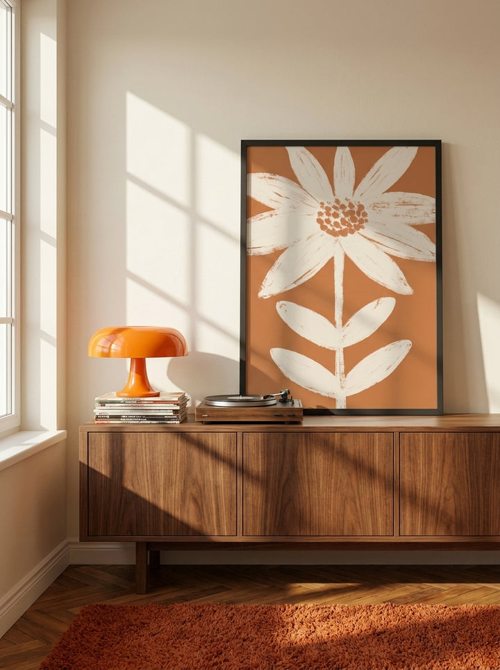 Modern wall art print standing on a sideboard in a retro 70s bedroom