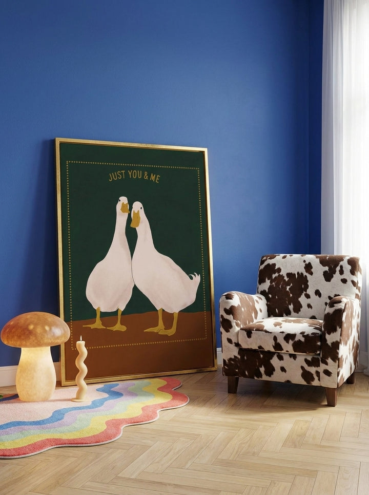 Canvas wall art with a gold leaf surround leaning against the wall in a colourful eclectic nursery