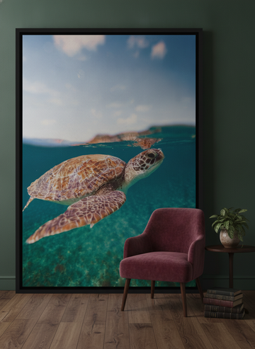 Oversized statement canvas wall art with a black surround leaning against the wall in a moody living room