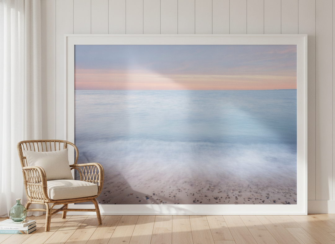 Oversized statement modern wall art print leaning against the wall in a coastal living room
