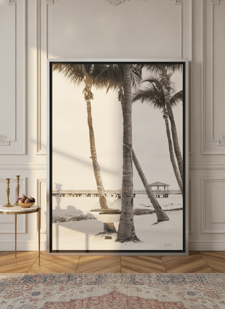 Oversized statement canvas wall art with a silver leaf surround leaning against the wall in a Parisian living room