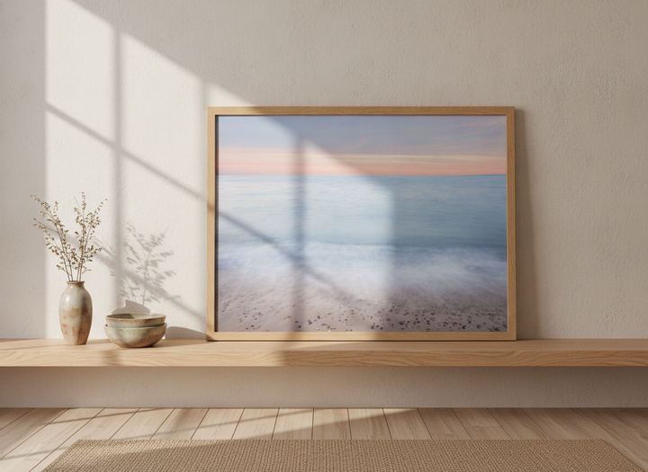 Modern wall art print standing on a shelf in a warm Japandi bathroom