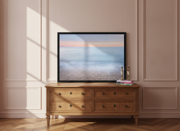 Canvas wall art with a black surround standing on a sideboard in a Parisian bathroom