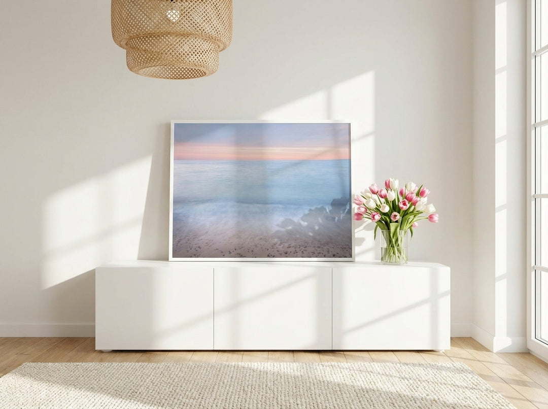 Modern wall art print standing on a sideboard in a bright Scandinavian bedroom