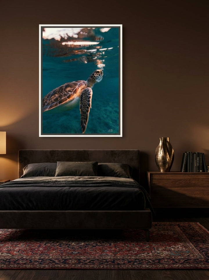 Canvas wall art with a white surround styled on the wall in a moody bedroom