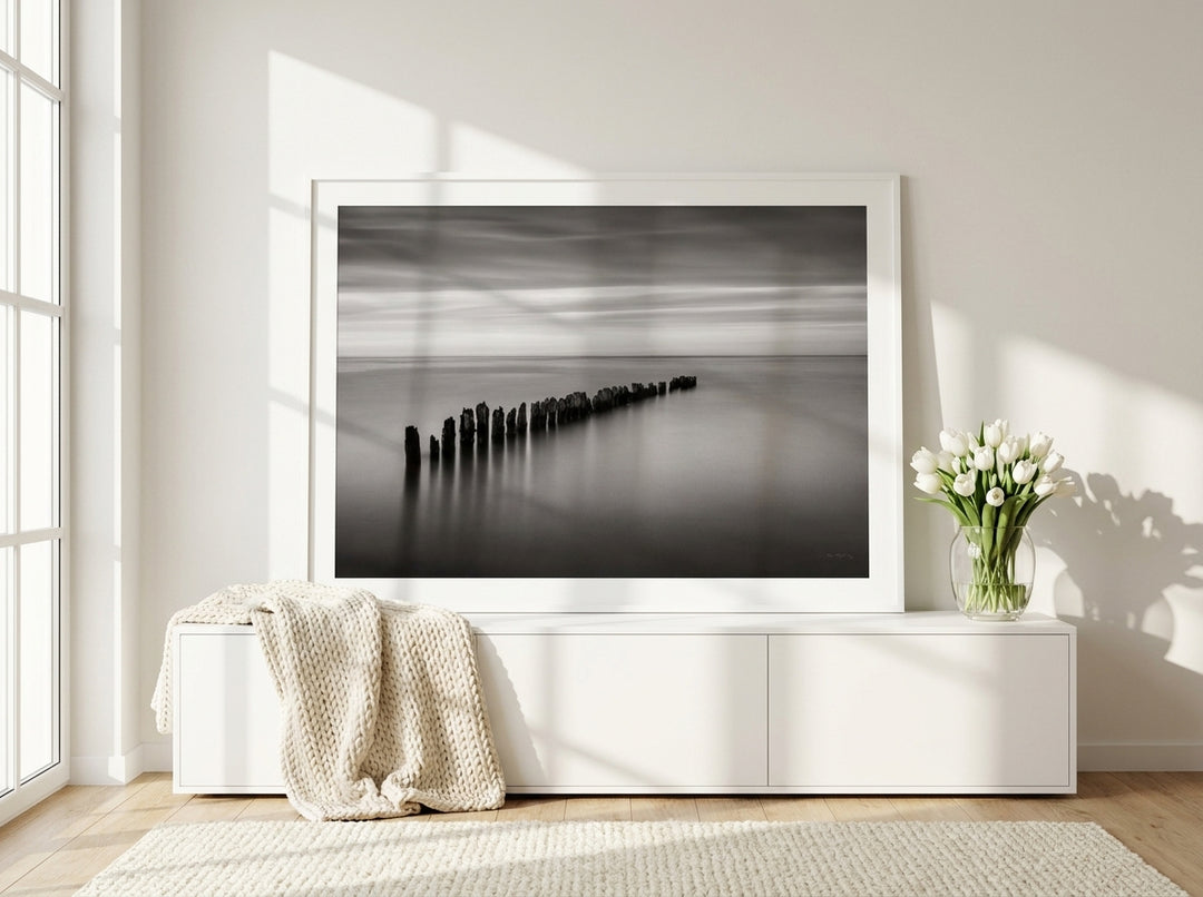 Modern wall art print standing on a sideboard in a bright Scandinavian home office