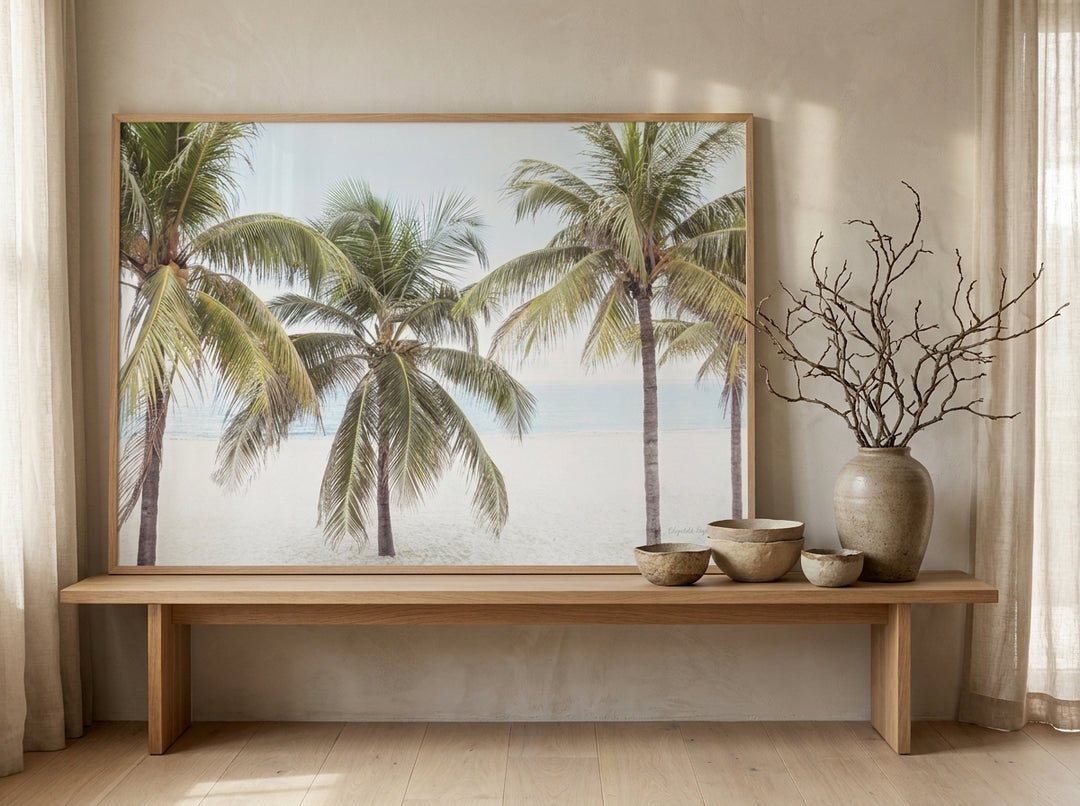 Modern wall art print standing on a bench in a warm Japandi bathroom