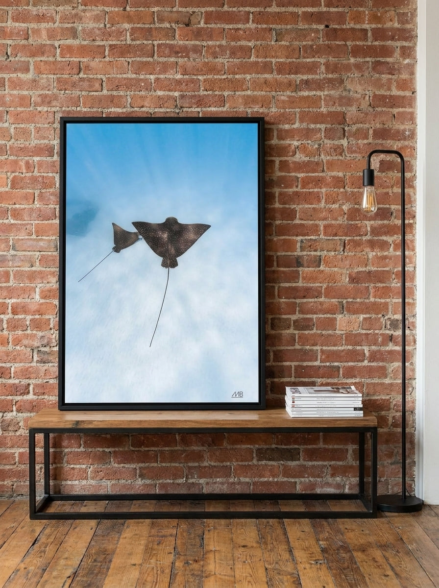 Canvas wall art with a black surround standing on a console in an industrial loft bedroom