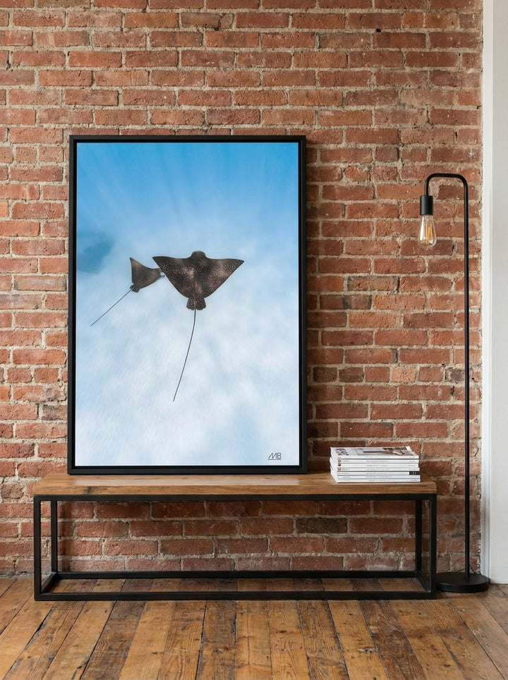 Canvas wall art with a black surround standing on a console in an industrial loft bedroom