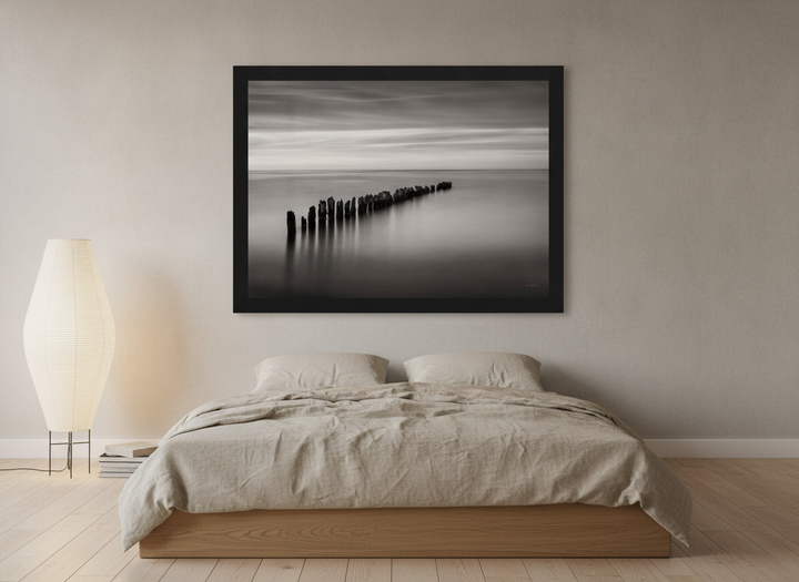 Oversized statement modern wall art print styled on the wall in a warm Japandi bedroom