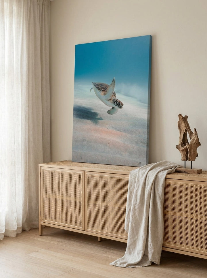 Stretched canvas wall art standing on a sideboard in a coastal dining room