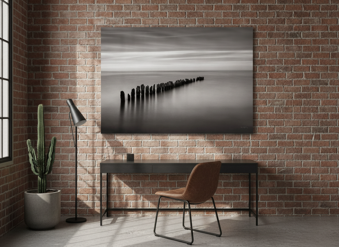 Stretched canvas wall art styled on the wall in an industrial loft home office