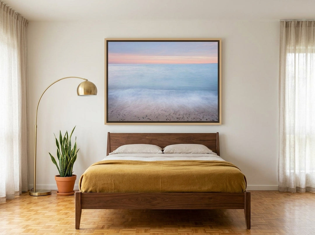 Oversized statement canvas wall art with a natural timber surround styled on the wall in a mid-century bedroom