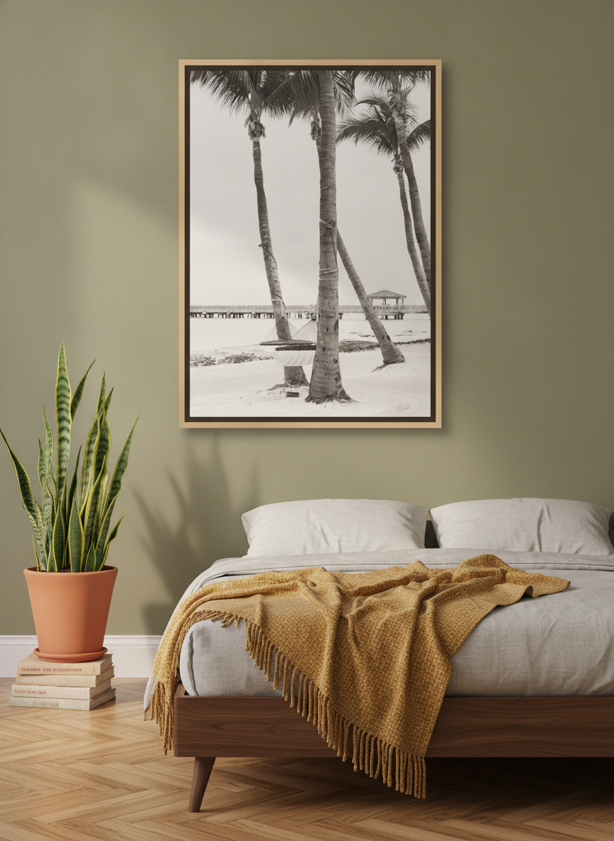 Canvas wall art with a natural timber surround styled on the wall in a mid-century bedroom