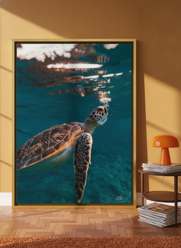 Oversized statement canvas wall art with a gold leaf surround leaning against the wall in a retro 70s home office