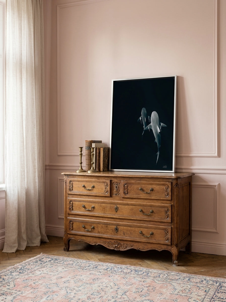 Canvas wall art with a silver leaf surround standing on a sideboard in a Parisian home office