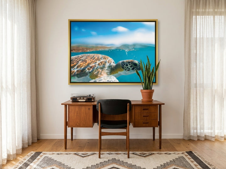Canvas wall art with a gold leaf surround styled on the wall in a mid-century home office