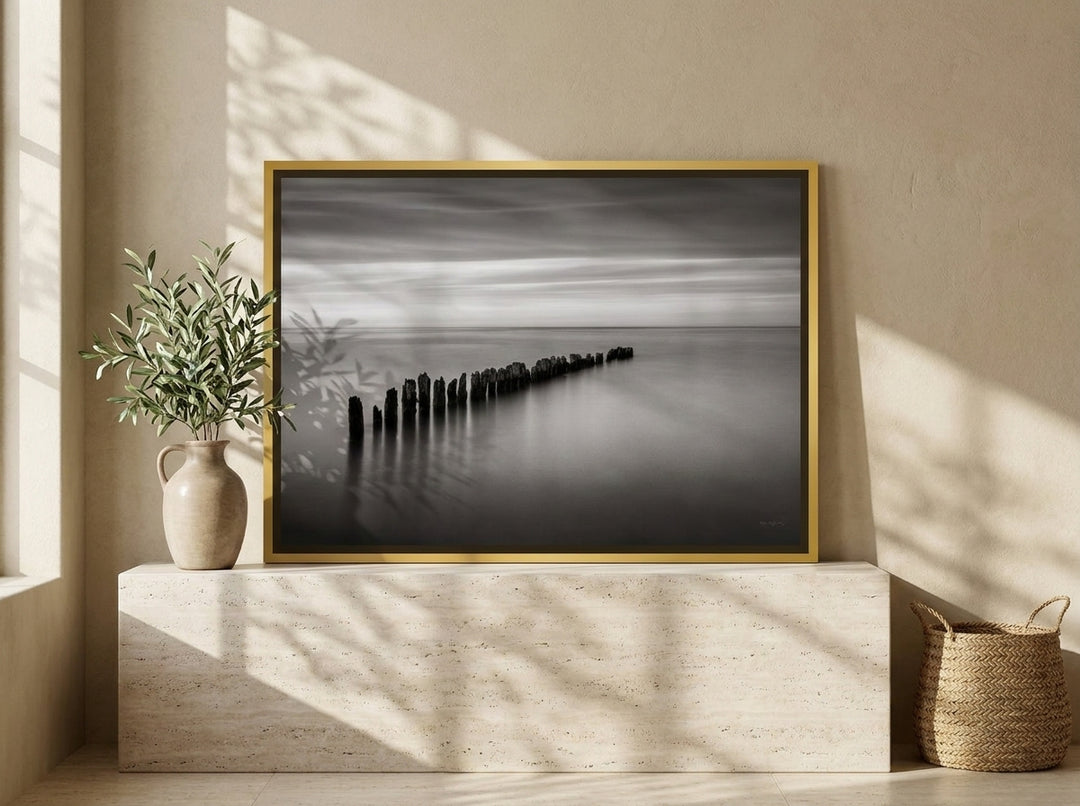 Canvas wall art with a gold leaf surround standing on a console in a Mediterranean home office