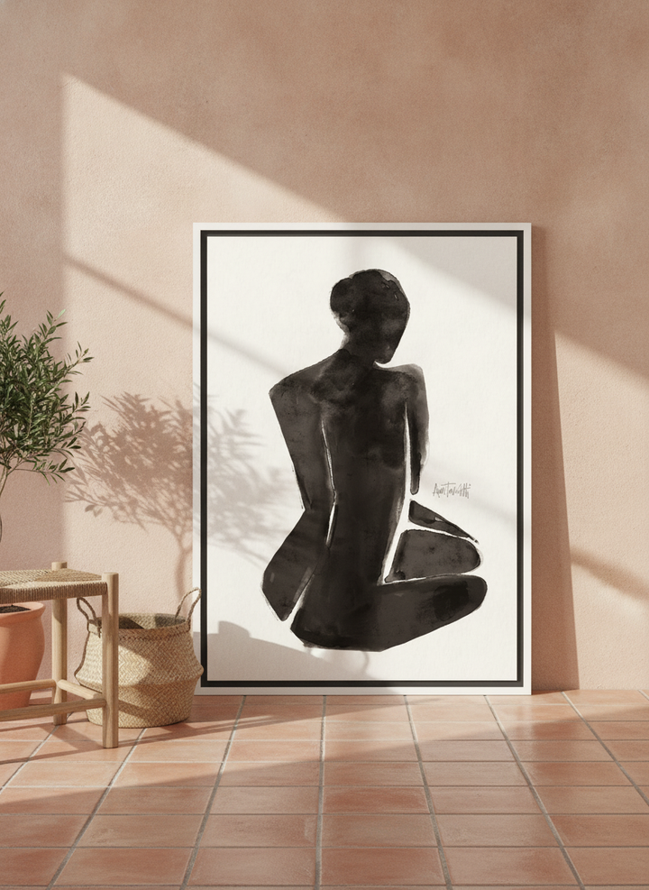 Canvas wall art with a white surround leaning against the wall in a Mediterranean bathroom