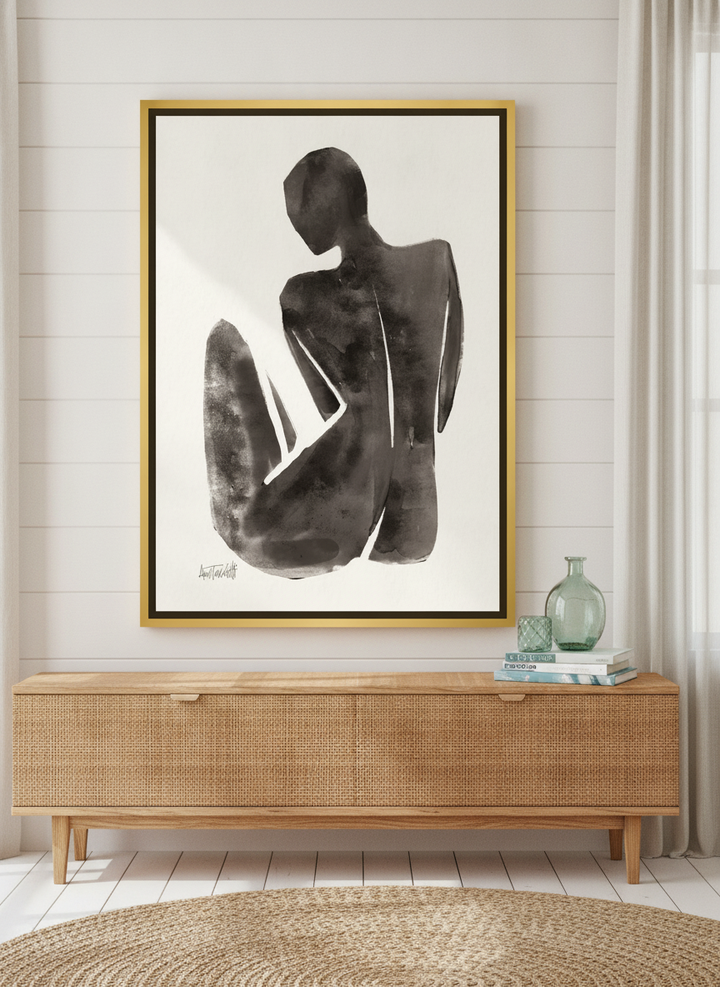 Canvas wall art with a gold leaf surround standing on a sideboard in a coastal home office
