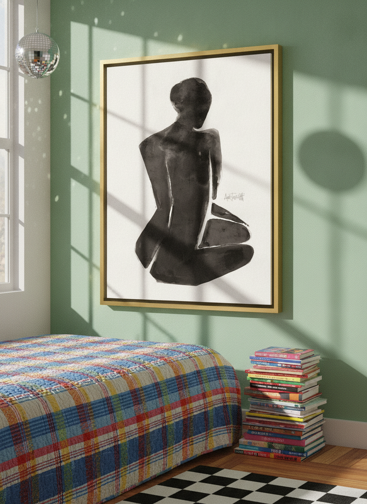 Canvas wall art with a gold leaf surround styled on the wall in a colourful eclectic bedroom