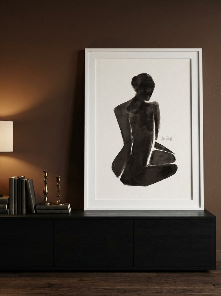 Modern wall art print standing on a console in a moody home office