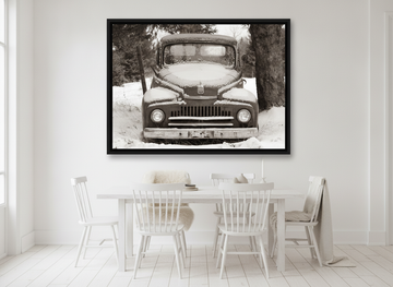 Oversized statement canvas wall art with a black surround styled on the wall in a bright Scandinavian dining room