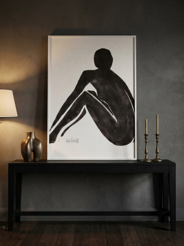 Modern wall art print standing on a console in a moody bedroom