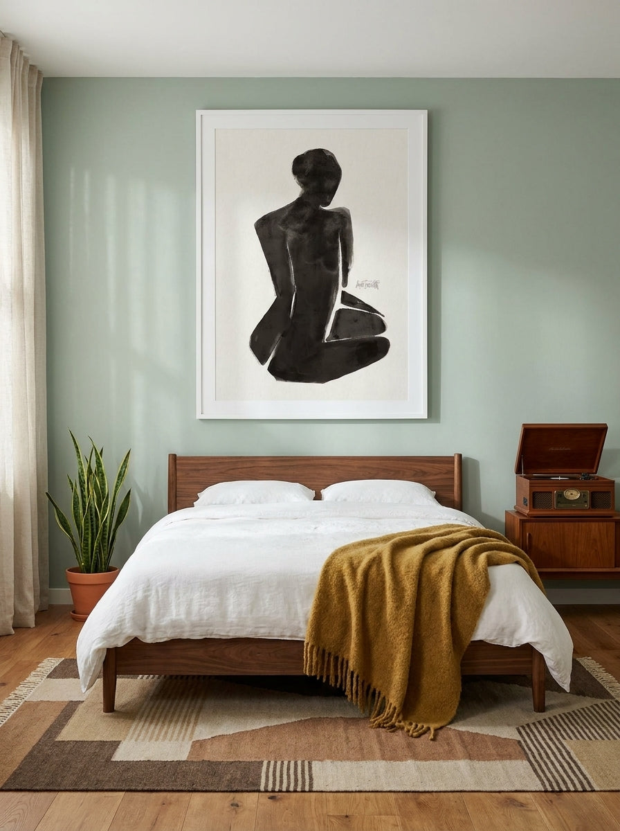 Modern wall art print styled on the wall in a mid-century bedroom