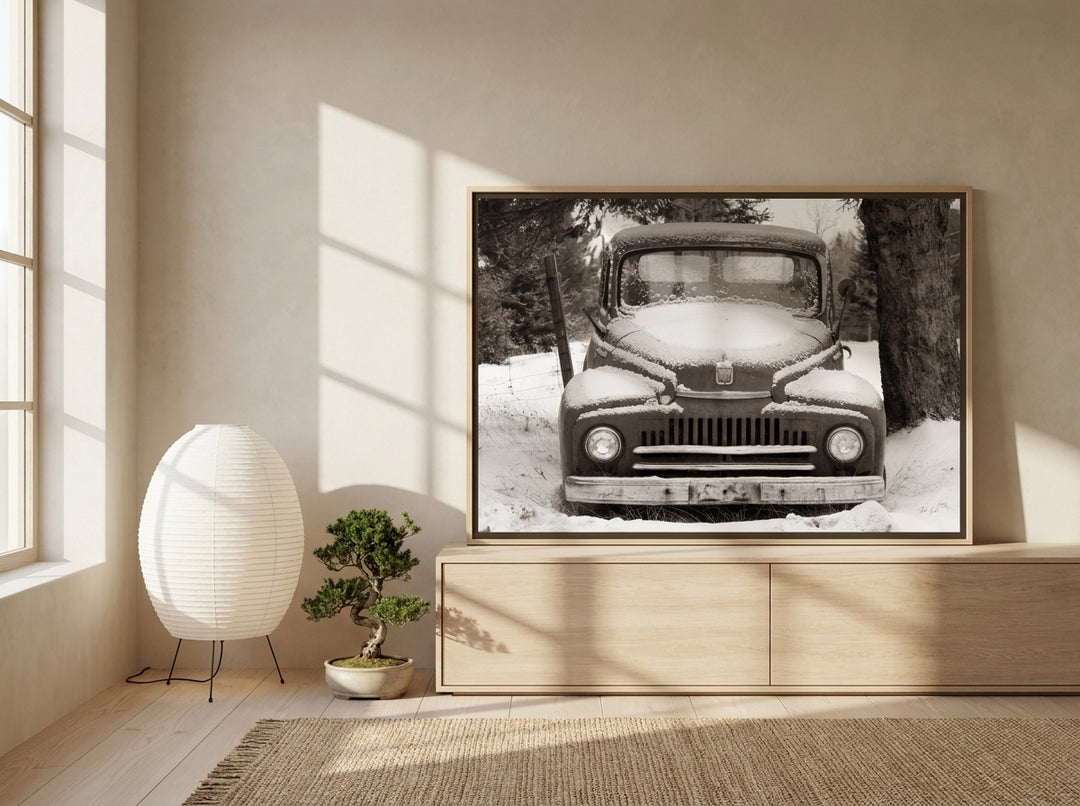 Canvas wall art with a natural timber surround standing on a sideboard in a warm Japandi bedroom