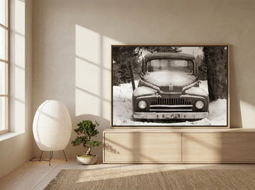 Canvas wall art with a natural timber surround standing on a sideboard in a warm Japandi bedroom