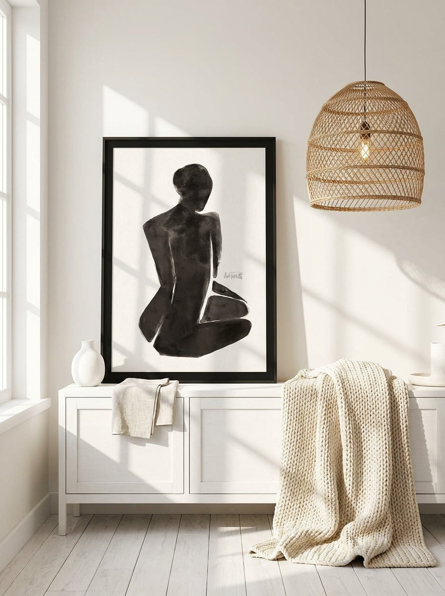 Modern wall art print standing on a sideboard in a bright Scandinavian bathroom