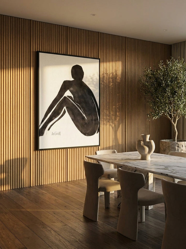 Oversized statement canvas wall art with a black surround styled on the wall in a luxe dining room
