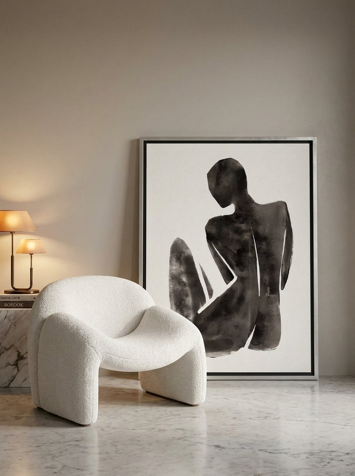 Canvas wall art with a silver leaf surround leaning against the wall in a luxe living room