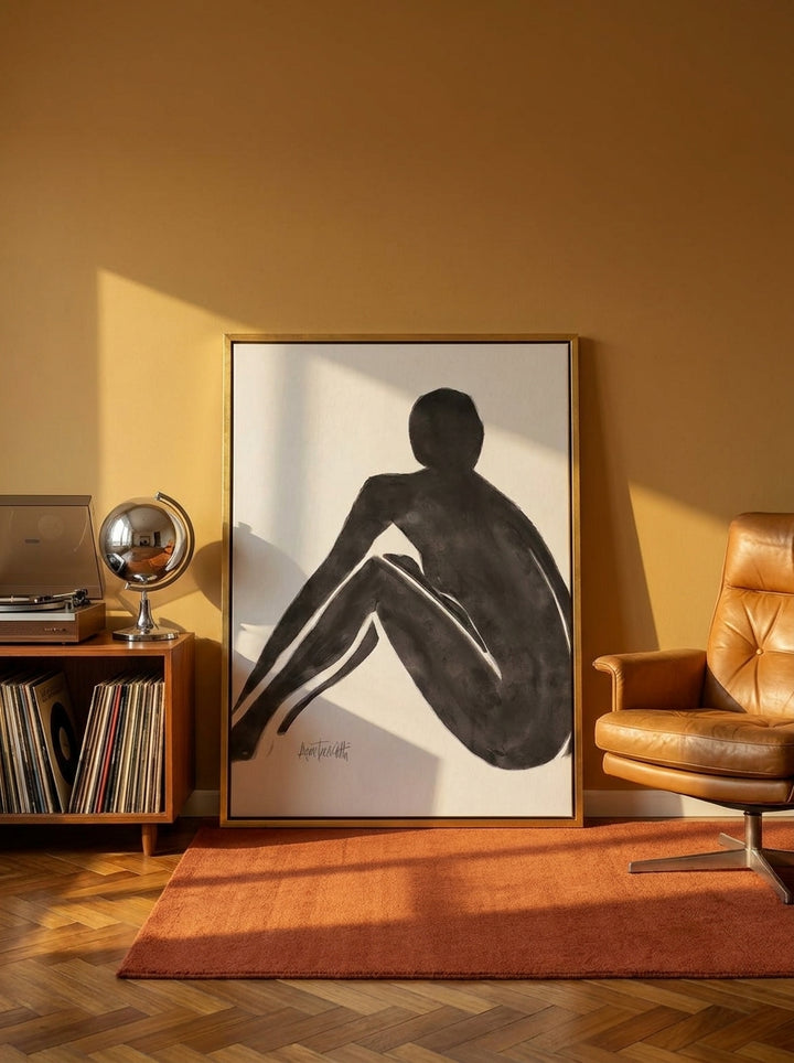 Canvas wall art with a gold leaf surround leaning against the wall in a retro 70s bedroom