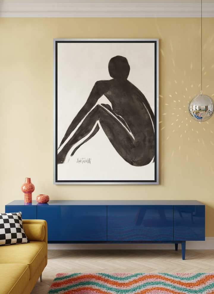 Oversized statement canvas wall art with a silver leaf surround styled on the wall in a colourful eclectic living room
