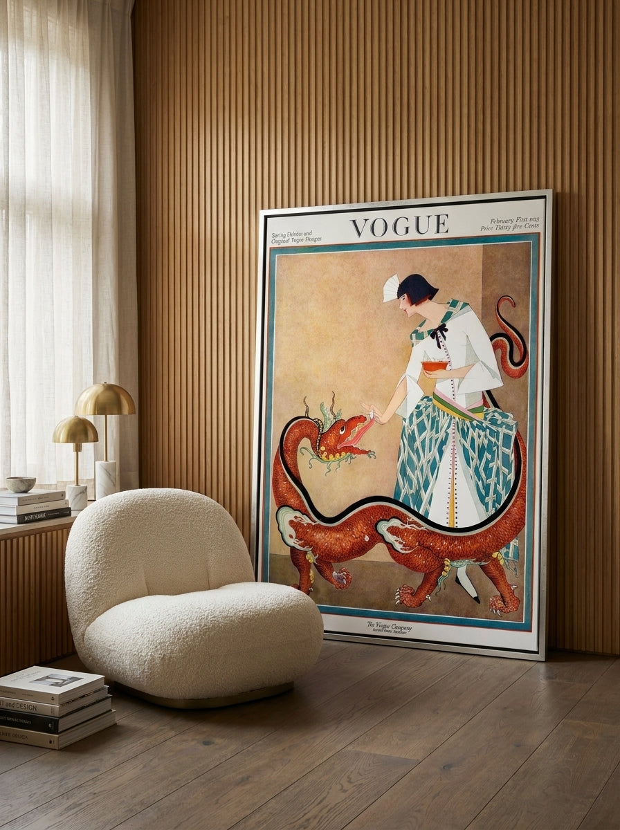 Oversized statement canvas wall art with a silver leaf surround leaning against the wall in a luxe dining room