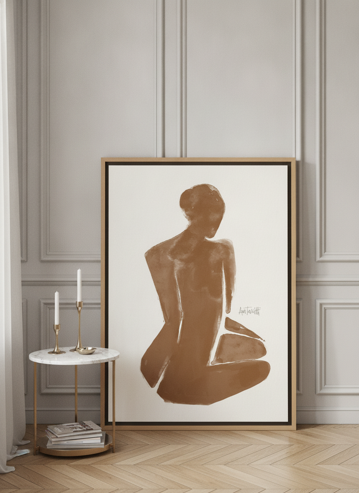 Canvas wall art with a natural timber surround leaning against the wall in a Parisian bathroom