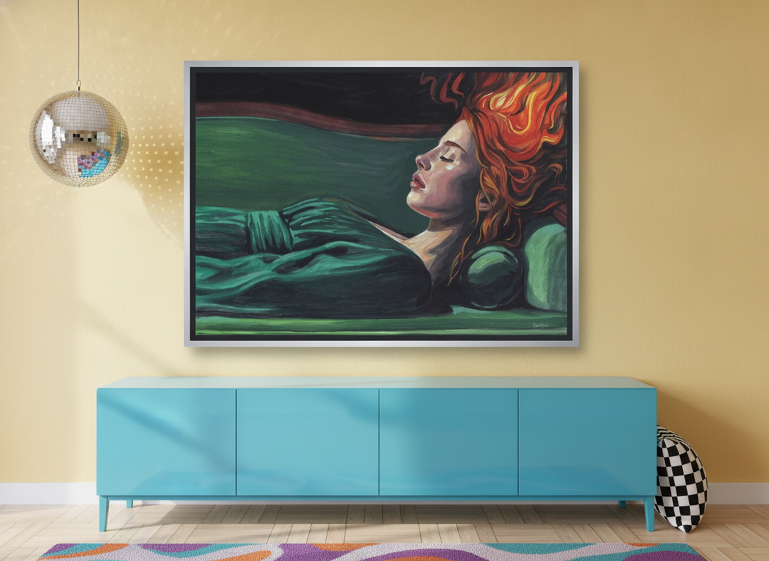 Canvas wall art with a silver leaf surround standing on a sideboard in a colourful eclectic bedroom