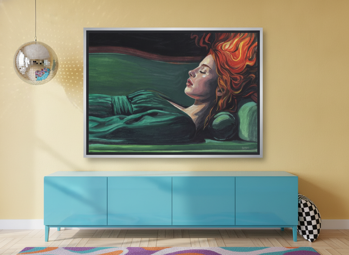 Canvas wall art with a silver leaf surround standing on a sideboard in a colourful eclectic bedroom
