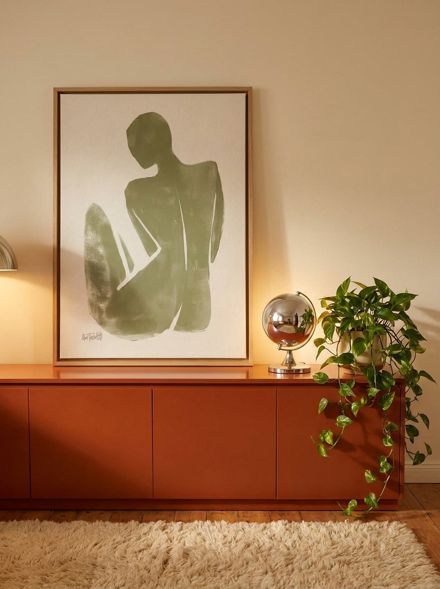 Canvas wall art with a natural timber surround standing on a sideboard in a retro 70s home office