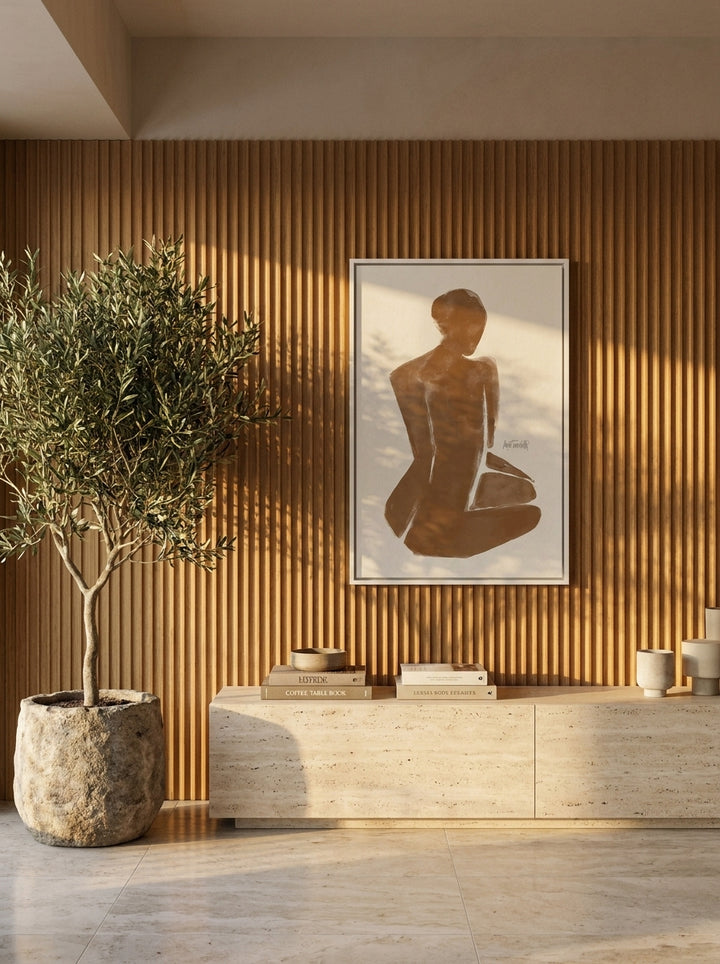 Oversized statement canvas wall art with a white surround styled on the wall in a luxe living room