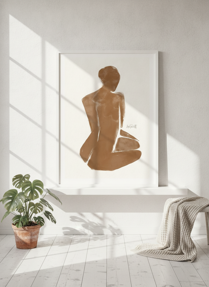 Modern wall art print standing on a shelf in a bright Scandinavian bathroom