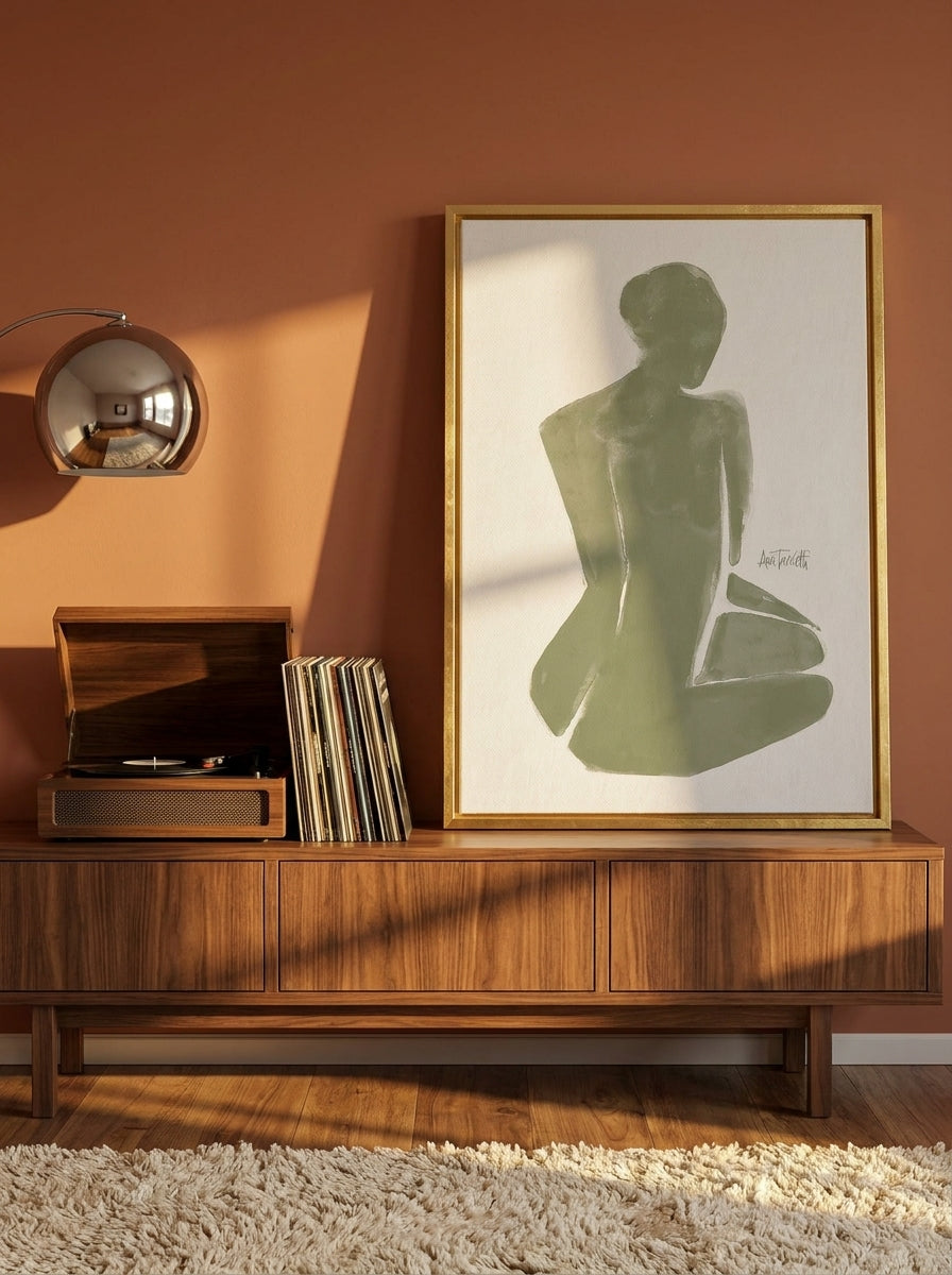 Canvas wall art with a gold leaf surround standing on a sideboard in a retro 70s bedroom