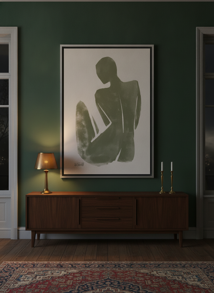 Oversized statement canvas wall art with a silver leaf surround styled on the wall in a moody living room
