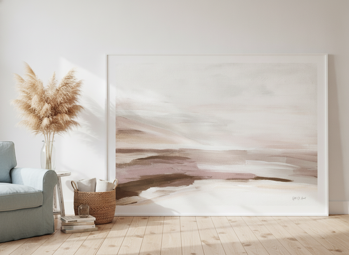 Oversized statement modern wall art print leaning against the wall in a coastal living room