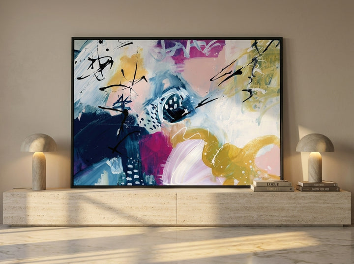 Modern wall art print standing on a console in a luxe home office