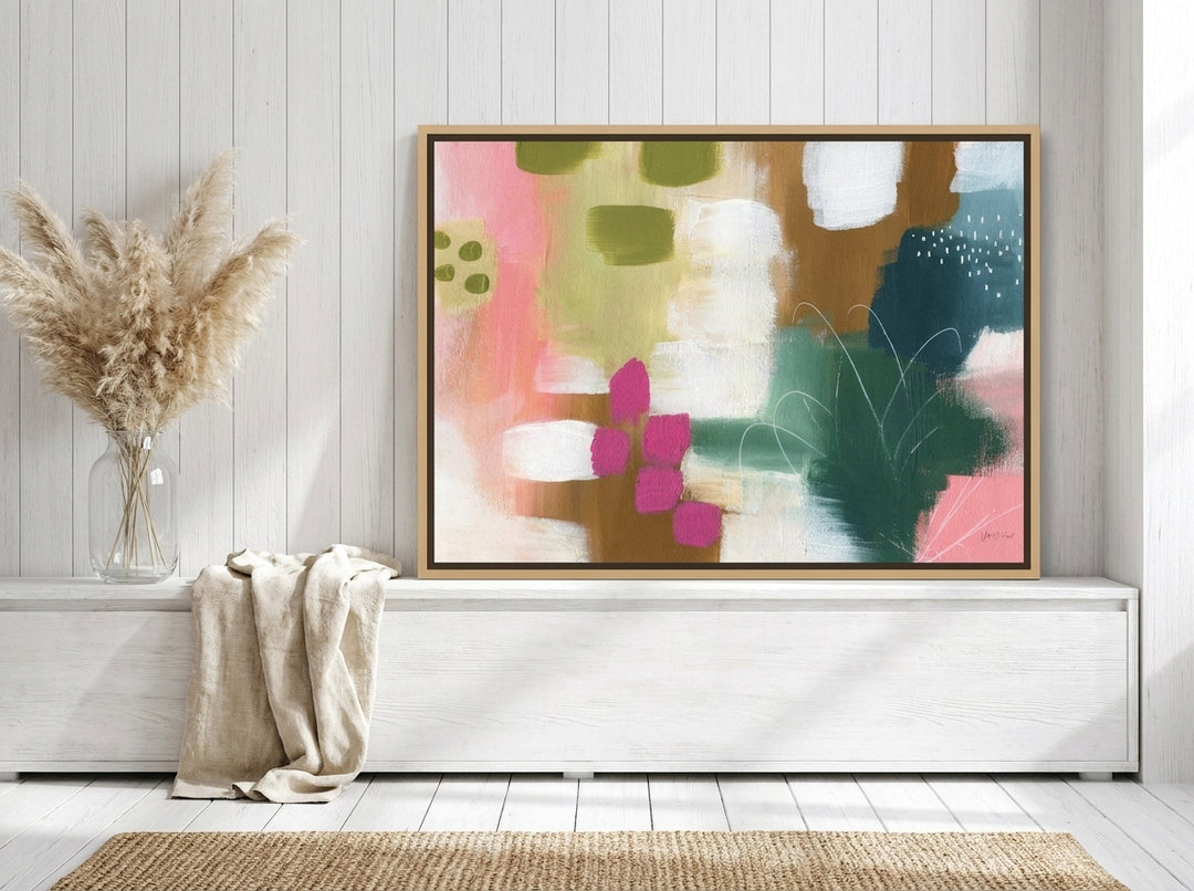 Canvas wall art with a natural timber surround standing on a console in a coastal home office